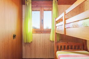 a bedroom with two bunk beds and a window at Las tres hermanas in Conil de la Frontera