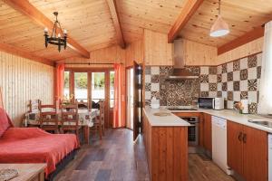 a kitchen and dining room with wooden walls and wooden floors at Las tres hermanas in Conil de la Frontera