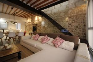 a living room with a couch and a stone wall at Centric in Sa Pobla