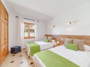 a hotel room with two beds and a window at Villa Manresa in Alcudia