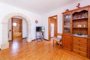 a large living room with a large wooden cabinet at Villa Jacoba in Cala Mondrago