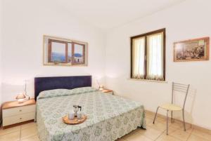 a bedroom with a bed and a table and a chair at Appartamenti Le Querce - Lentisco in Capoliveri