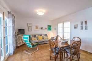 a living room with a table and a couch at White Sands 3.07 in Arenal d'en Castell