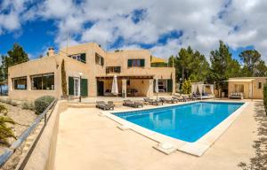 a home with a swimming pool in front of a house at Can Moustique in Sant Josep de sa Talaia