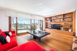 a living room with a red couch and a table at Marítimo 46 in Alcudia