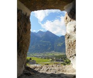 a view of mountains from a window in a castle at La Luge in Saint-Christophe