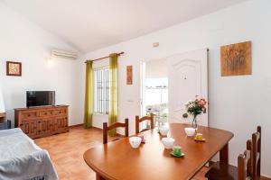 a living room with a table and a couch at Casa Palillero - Sólo Familias in Conil de la Frontera