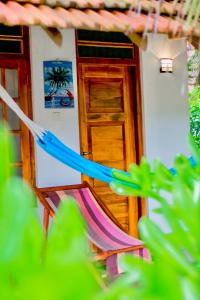 a house with a hammock in front of it at Star Light Cabanas & Restaurant in Tangalle