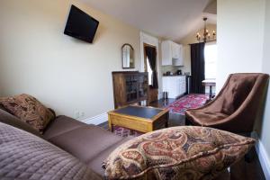 a living room with a couch and a table at Dickson Street Inn in Fayetteville