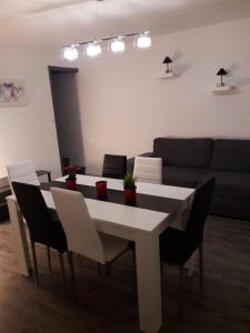 a living room with a table and chairs and a couch at Jolie maison de campagne in Fresnes-en-Woëvre