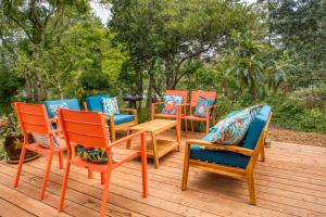 a group of chairs and tables on a deck at Sehome Garden Inn in Bellingham +9 photos