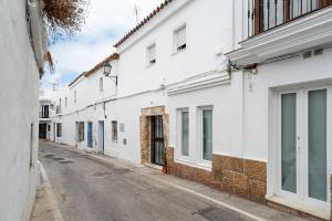 an empty street with white buildings at Apartamento Lola - Sólo Familias in Conil de la Frontera