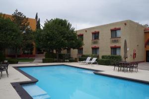 a large swimming pool in front of a building at Casa Grande Chihuahua in Chihuahua