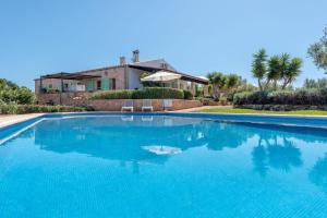 a large swimming pool in front of a house at Casa Yolanda in Sant Llorenç des Cardassar
