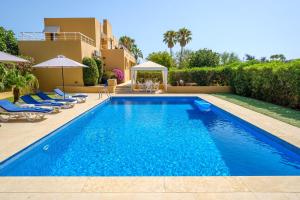 a swimming pool in the backyard of a house at Villa Sunrise in Sant Josep de sa Talaia