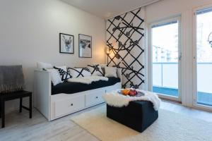 a bedroom with a bed and a desk and a window at Vasko luxurious suites, Mustikka in Rovaniemi