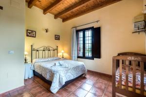 a bedroom with a bed and a window at Casa Rural Loma El Letrao in Almogía +29 photos