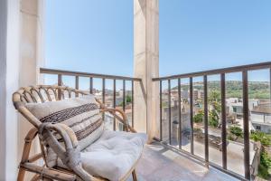 a rocking chair on a balcony with a view at Bennassar 2 in Felanitx +14 photos