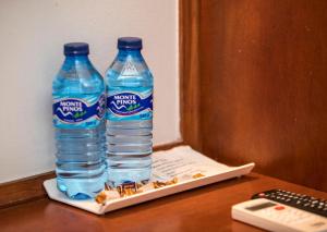 two bottles of water on a tray on a desk at Hotel Alba in Soria