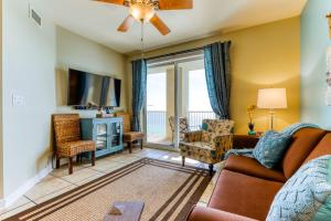 a living room with a couch and a tv at Grand Panama Beach Resort #T1-1402 in Panama City Beach
