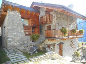 a stone house with a bike in front of it at La Luge in Saint-Christophe