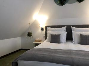 a bedroom with a large bed with white sheets and pillows at Arce Boutique in Braşov