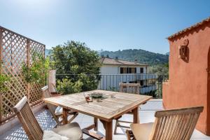 a wooden table and chairs on a patio at Apartament Carla in Port de Soller