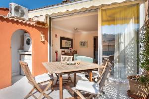 a patio with a wooden table and chairs at Apartament Carla in Port de Soller