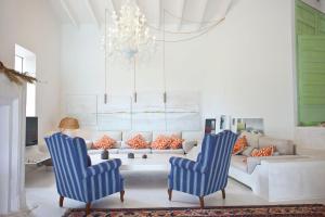 a living room with two blue chairs and a couch at Finca Calicant in Sant Llorenç des Cardassar