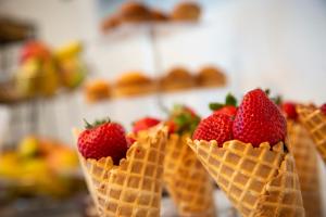 a row of ice cream cones with strawberries in them at Athens Central Hotel in Athens