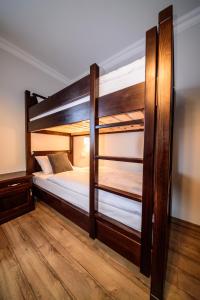 two bunk beds in a room with wooden floors at Willa Na Złotym Widoku in Piechowice