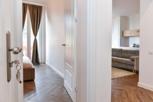 ボーソレイユにあるBeautiful Apartment next to Monte Carloのリビングルーム(ソファ付)へのオープンドア
