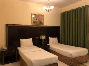 Katil atau katil-katil dalam bilik di New Royal Mark Hotel Apartments