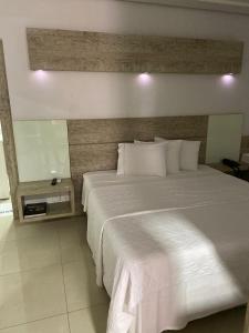 Кровать или кровати в номере Augusto Palace Hotel