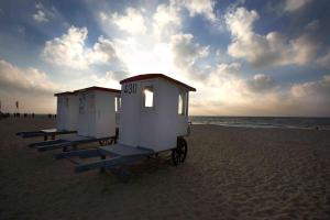 a row of small shelters on a beach at StrandHafen in Westerland (Sylt)