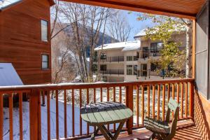 balkon ze stołem i krzesłem oraz budynek w obiekcie Coronet Creek Retreat w mieście Telluride