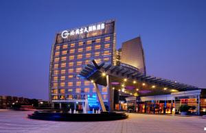 a building with a sculpture in front of it at Grand Skylight International Hotel Shenzhen Guanlan Avenue in Bao'an
