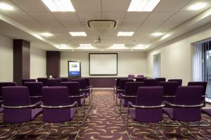 a conference room with purple chairs and a whiteboard at Holiday Inn Express Dunstable by IHG in Dunstable