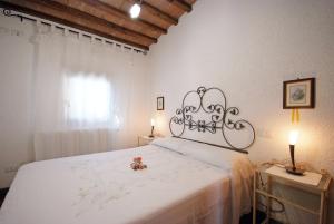 a bedroom with a large white bed with flowers on it at Il Villino Isola d'elba-ortano in Rio nellʼElba
