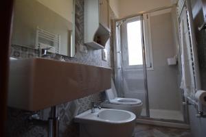 a bathroom with a sink and a toilet and a window at Il Cisto in Marciana