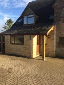 a detached house with a brick driveway at Blacklaines Annexe in Gloucester
