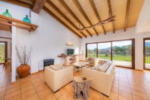 a living room with a couch and a table at Es clonanell in Capdepera
