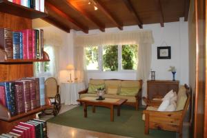 a living room with a couch and a table with books at El jardín de la abuela in Granada