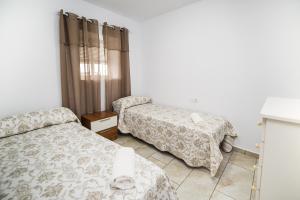 Posteľ alebo postele v izbe v ubytovaní Apartamento Chiclana 1