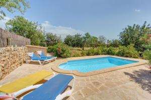 una piscina con due sedie a sdraio e una piscina di Casa Ventura a Portopetro