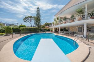 a swimming pool in front of a house at Villa Son Veri de la Marina in El Arenal