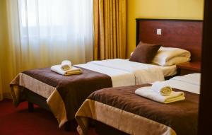 Postel nebo postele na pokoji v ubytování Hotel Piotr Spa&Wellness