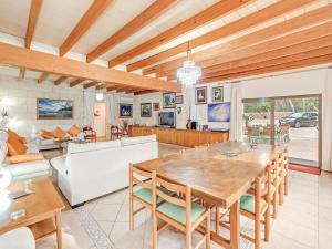 a dining room and living room with a table and chairs at El Bosque in Urbanicacion ses palmeres