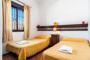 En eller flere senge i et værelse på Cortijo Villa La Dehesa