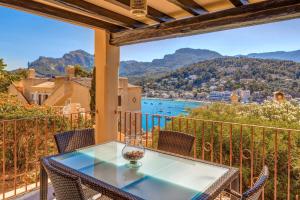 a table on a balcony with a view of the water at Montemar 33 in Port de Soller